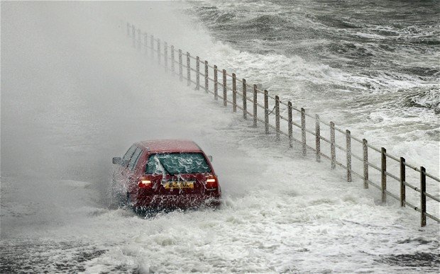 a car near the sea overwhelmed by water