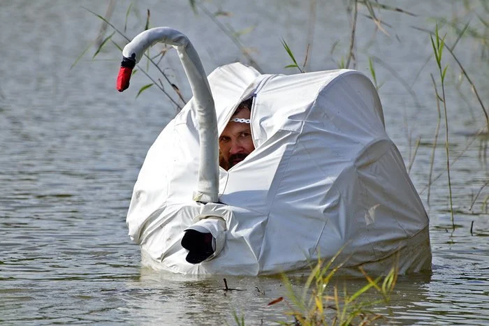 This image shows a man wearing a geese costume.