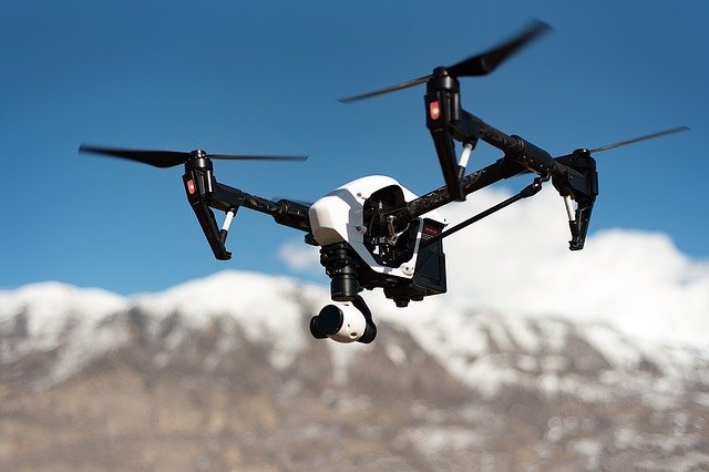 an image of a drone camera flying over mountains 