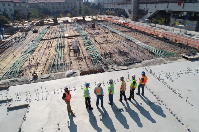 a camera view of construction workers standing in a jobsite 